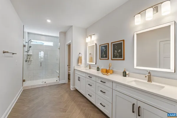 a spacious bathroom with double sink and a mirror