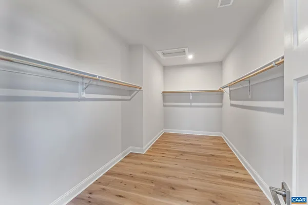 a bed room with a bed and a chair