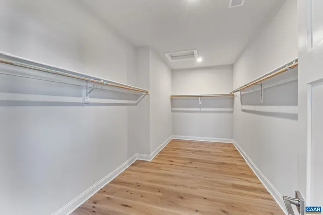 a bed room with a bed and a chair