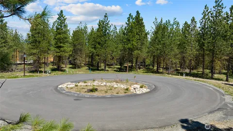 a swimming pool with trees in the background