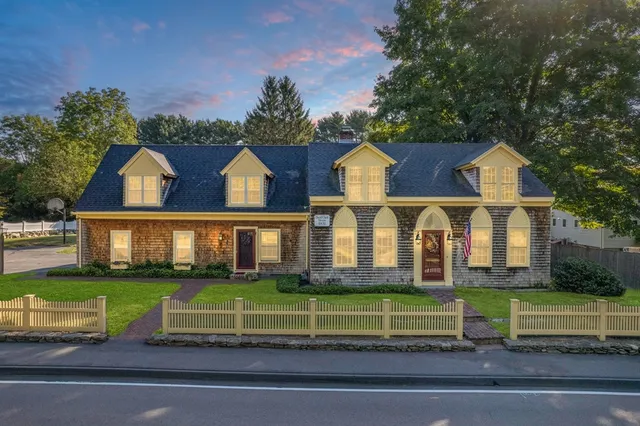 a front view of a house with a garden