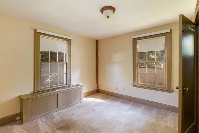 an empty room with windows and closet