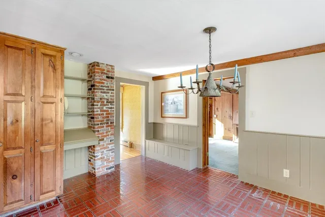 a view of empty room with wooden floor and windows