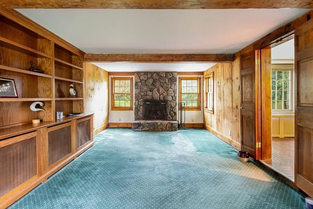 wooden floor in an empty room with a fireplace