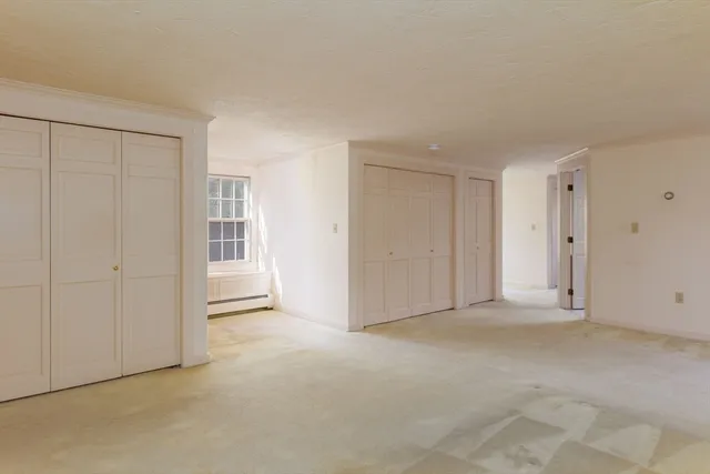 a view of an empty room with closet area