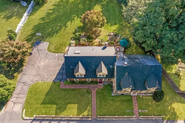 an aerial view of a house with swimming pool and garden
