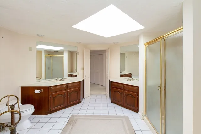 a spacious bathroom with a sink and a mirror