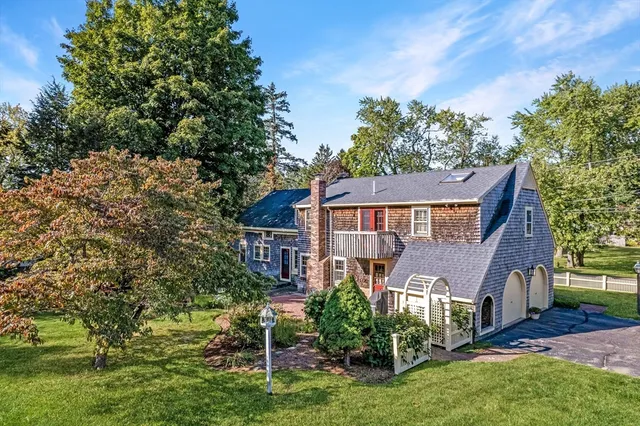 a front view of a house with a garden