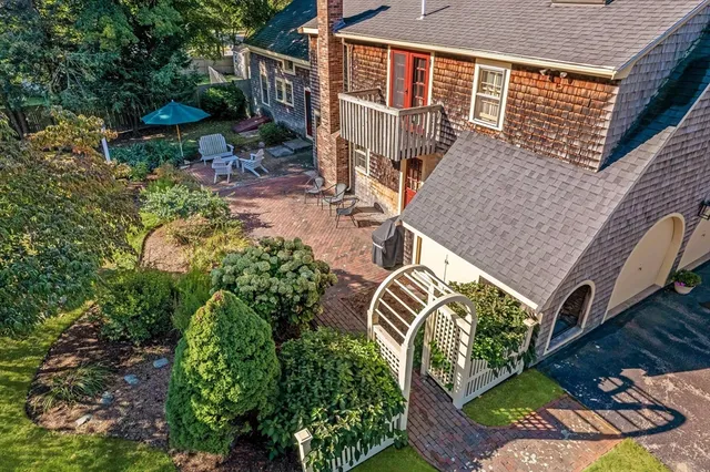 an aerial view of a house with a yard and potted plants