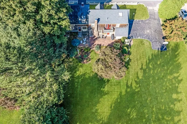 an aerial view of a house with a yard