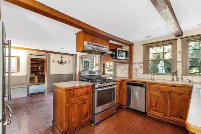 a kitchen with stainless steel appliances granite countertop a stove and a sink