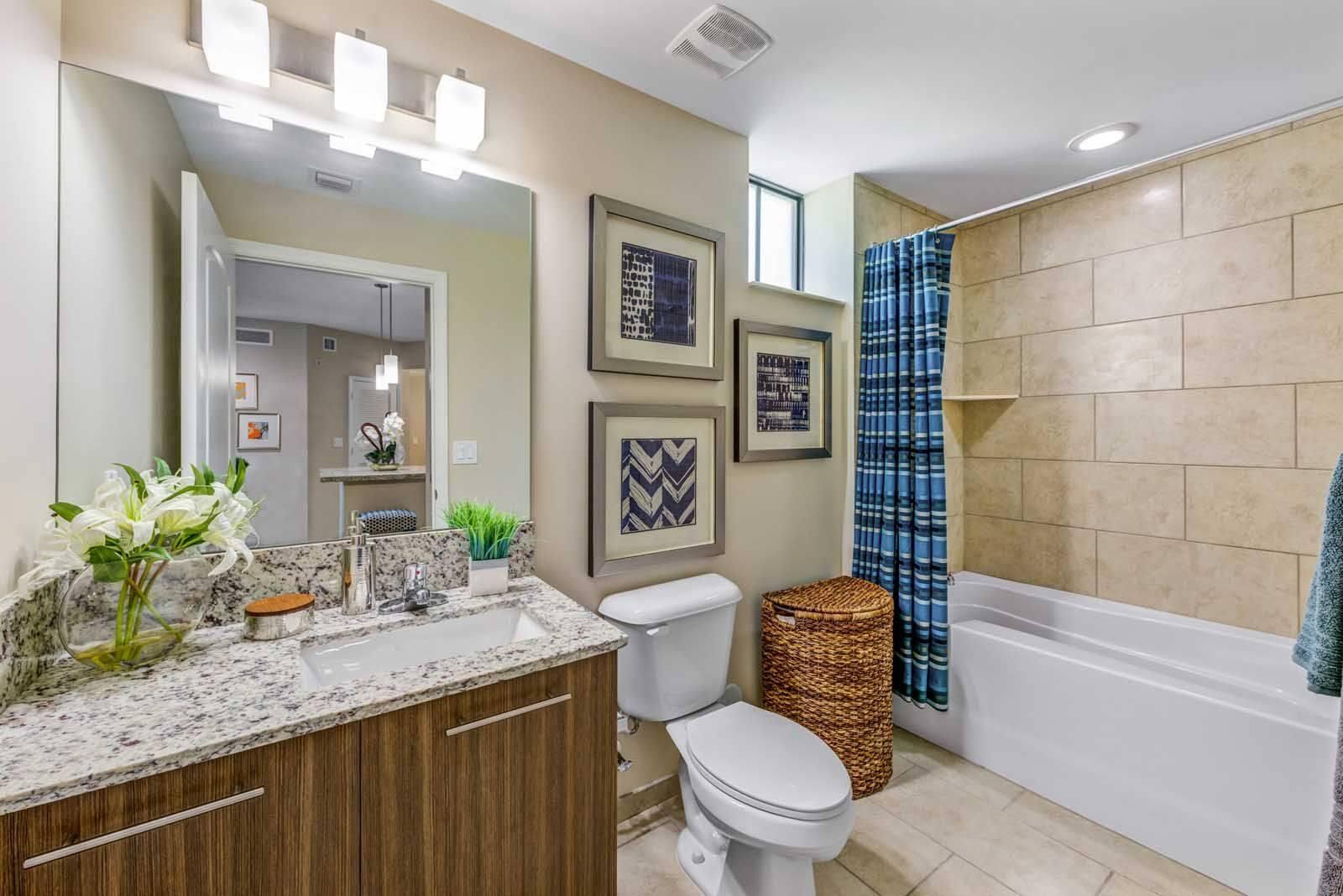 16808 Southwest 137th Avenue, Unit 934 Miami, FL 33177 - Photo 10 of 14 a bathroom with a granite countertop toilet a sink and a bathtub
