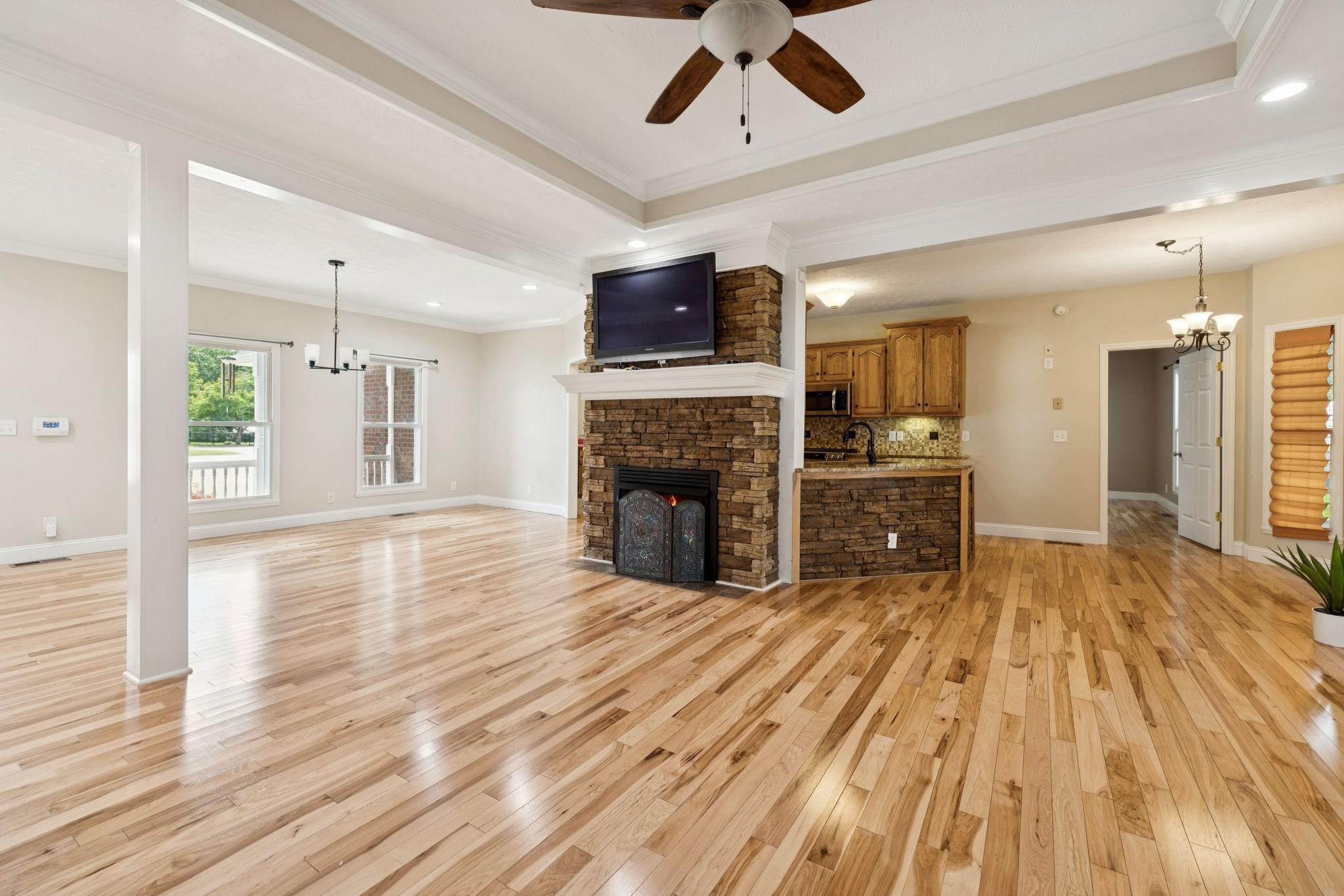 314 West Main Street Alexandria, TN 37012 - Photo 17 of 53 a view of a livingroom with a fireplace a ceiling fan and wooden floor