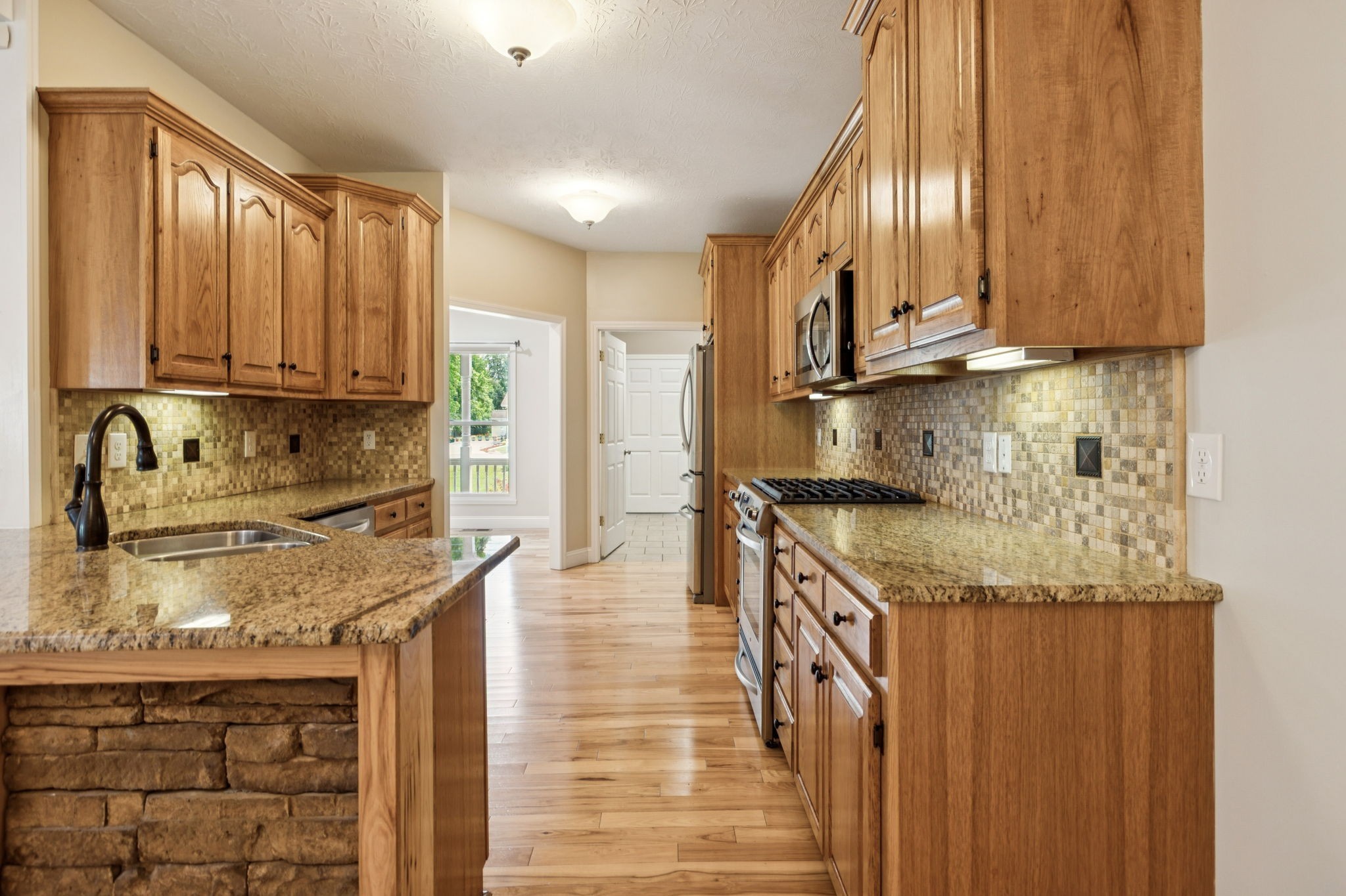 314 West Main Street Alexandria, TN 37012 - Photo 22 of 53 a kitchen with granite countertop a sink a stove and cabinets