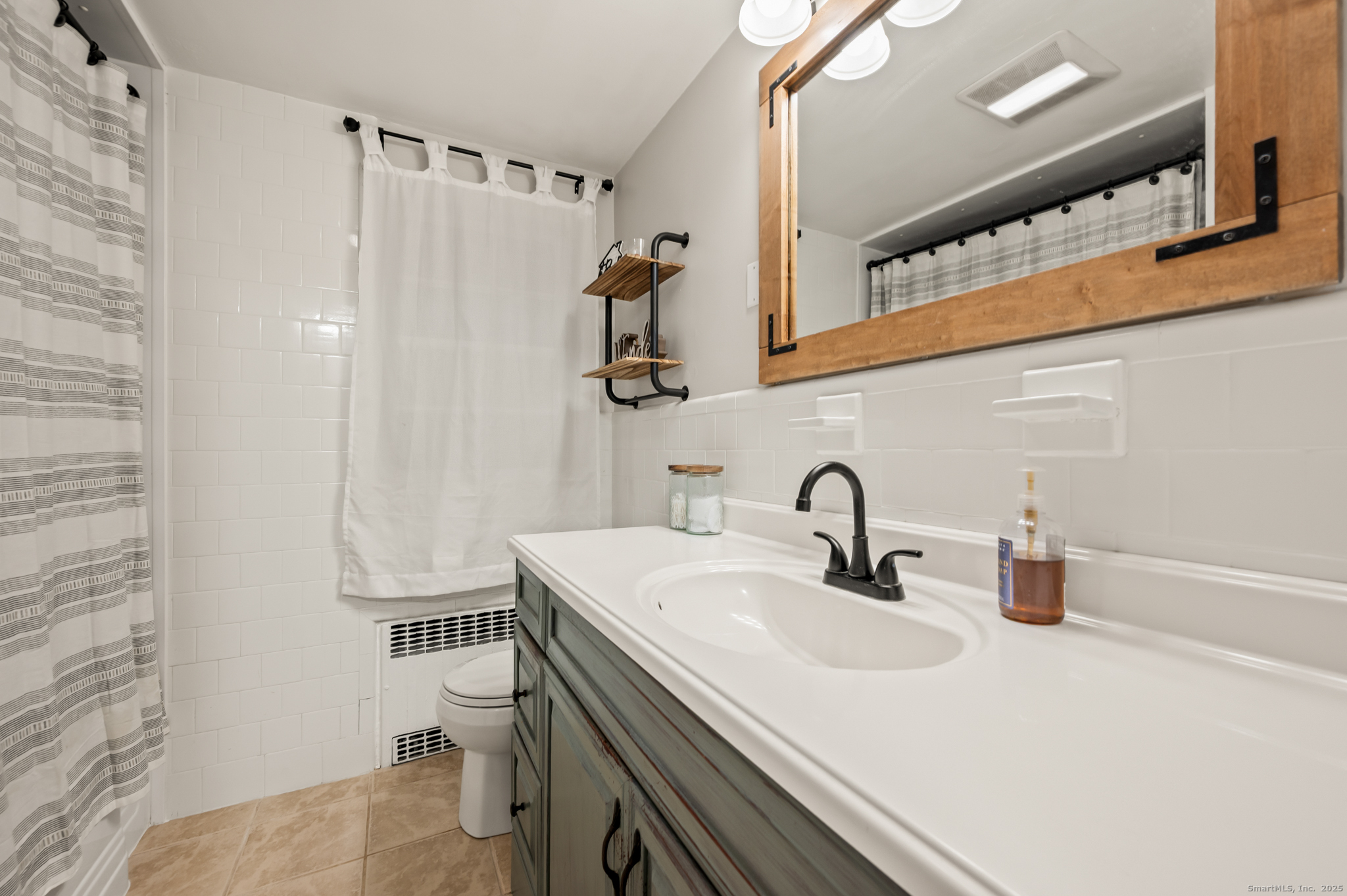 24 William Street Portland, CT 06480 - Photo 20 of 35 a bathroom with a sink and a mirror