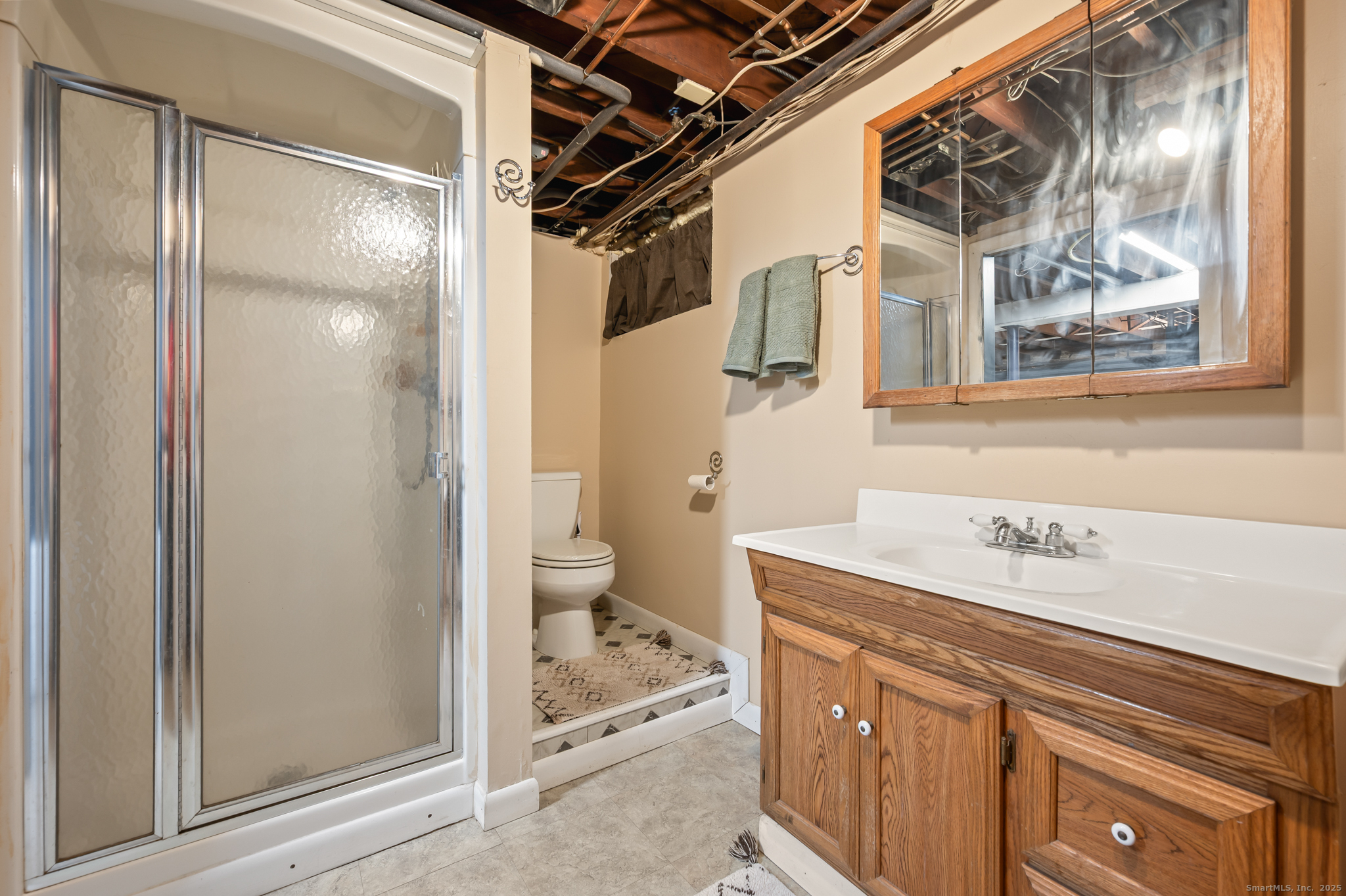 24 William Street Portland, CT 06480 - Photo 28 of 35 a bathroom with a sink and mirror with toilet