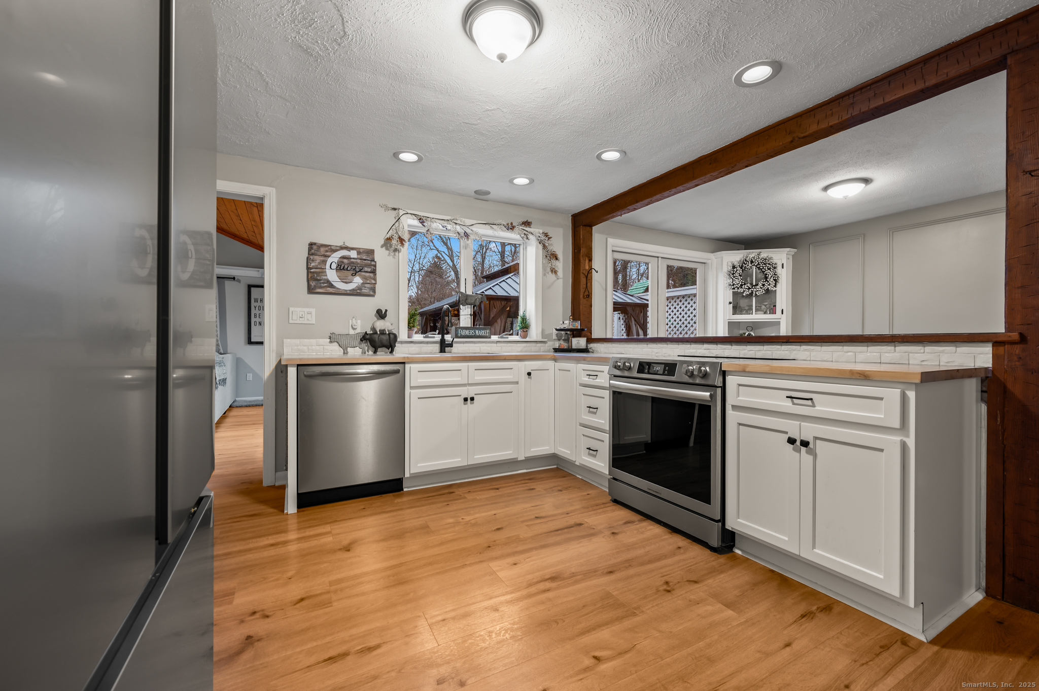 24 William Street Portland, CT 06480 - Photo 3 of 35 a kitchen with a sink cabinets stainless steel appliances and wooden floor