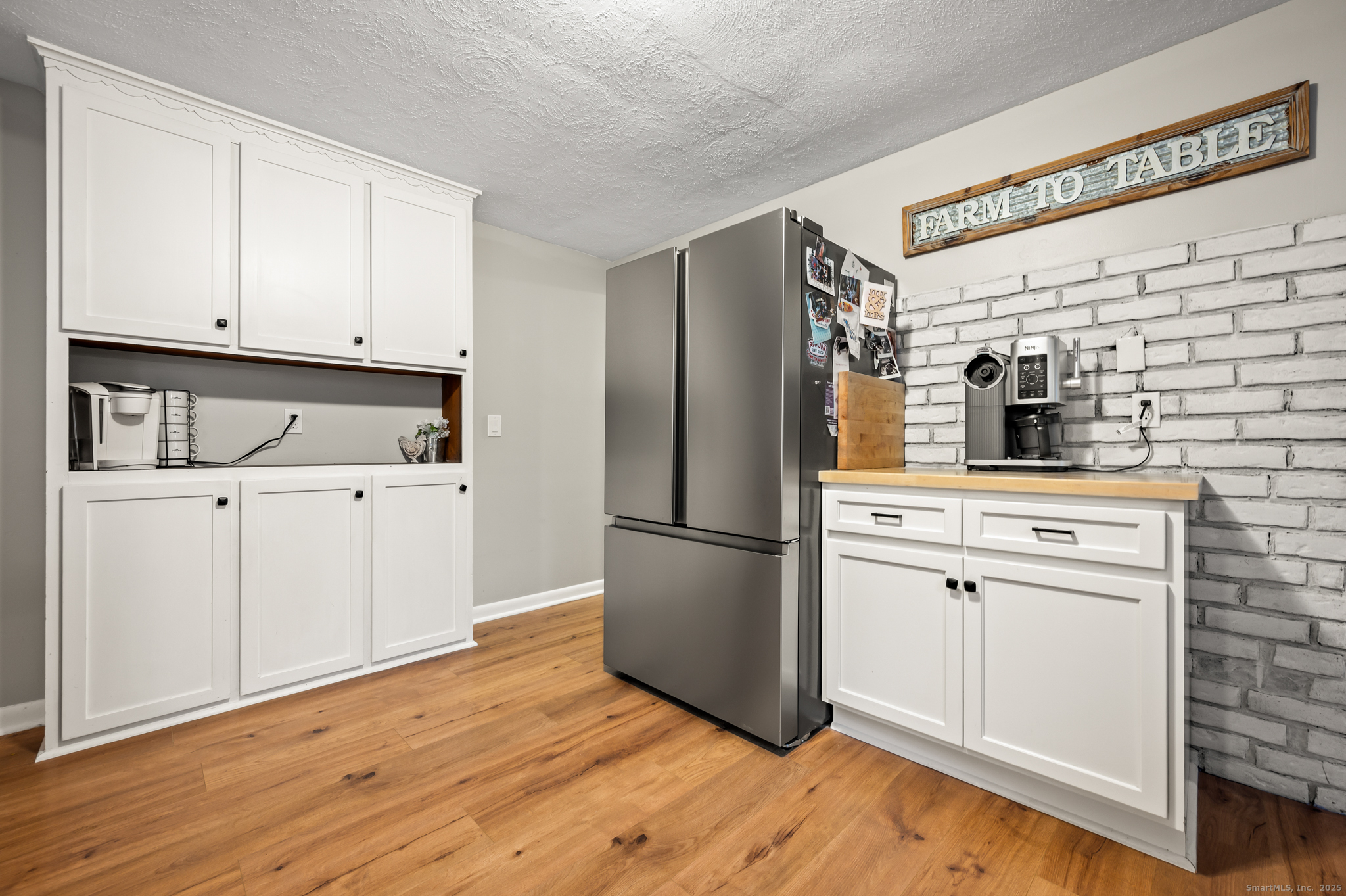 24 William Street Portland, CT 06480 - Photo 4 of 35 a kitchen with a refrigerator sink and cabinets
