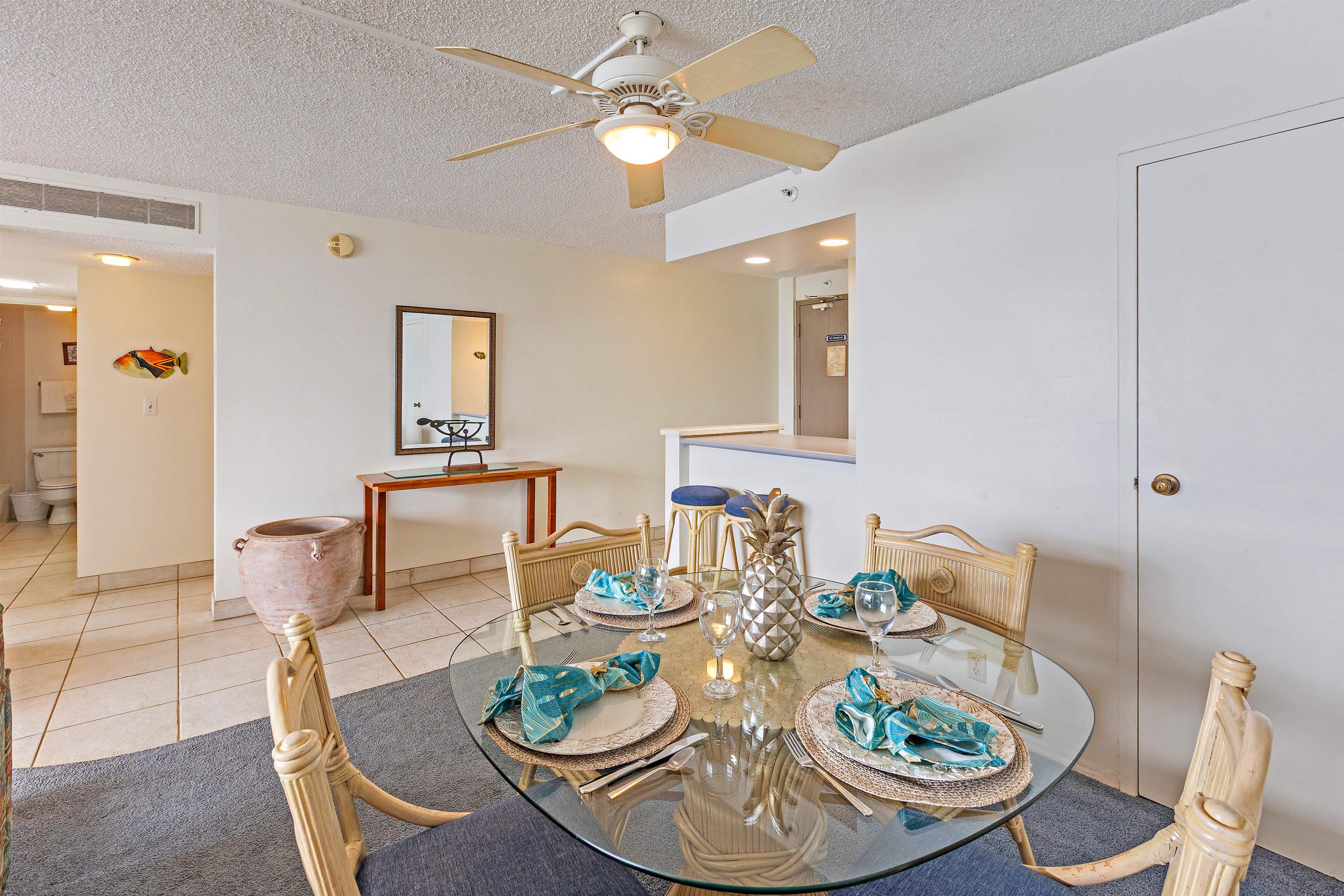 4327 Lower Honoapiilani Road, Unit 808 Lahaina, HI 96761 - Photo 15 of 35 a dining room with furniture a rug and wooden floor