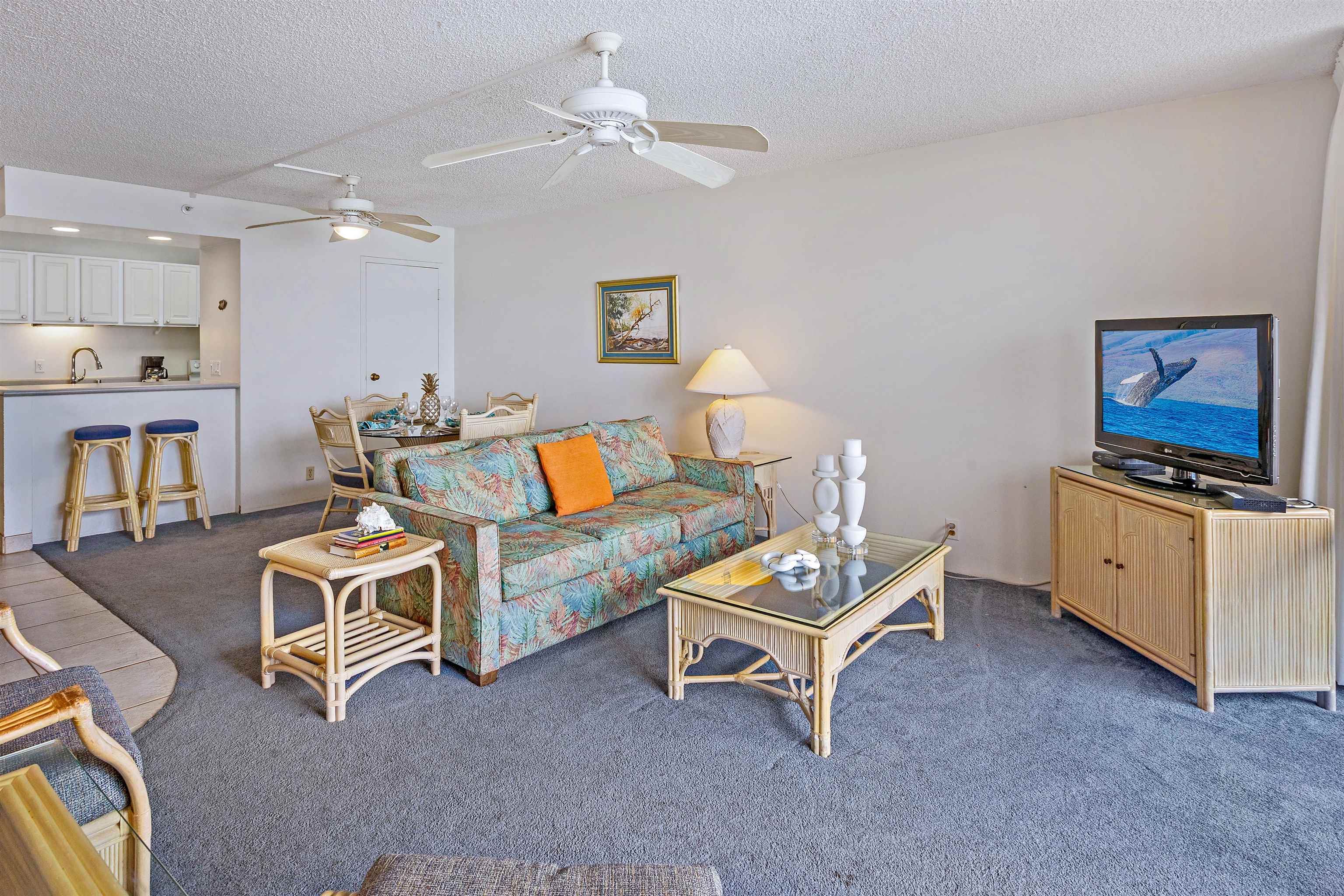 4327 Lower Honoapiilani Road, Unit 808 Lahaina, HI 96761 - Photo 18 of 35 a living room with furniture and a flat screen tv