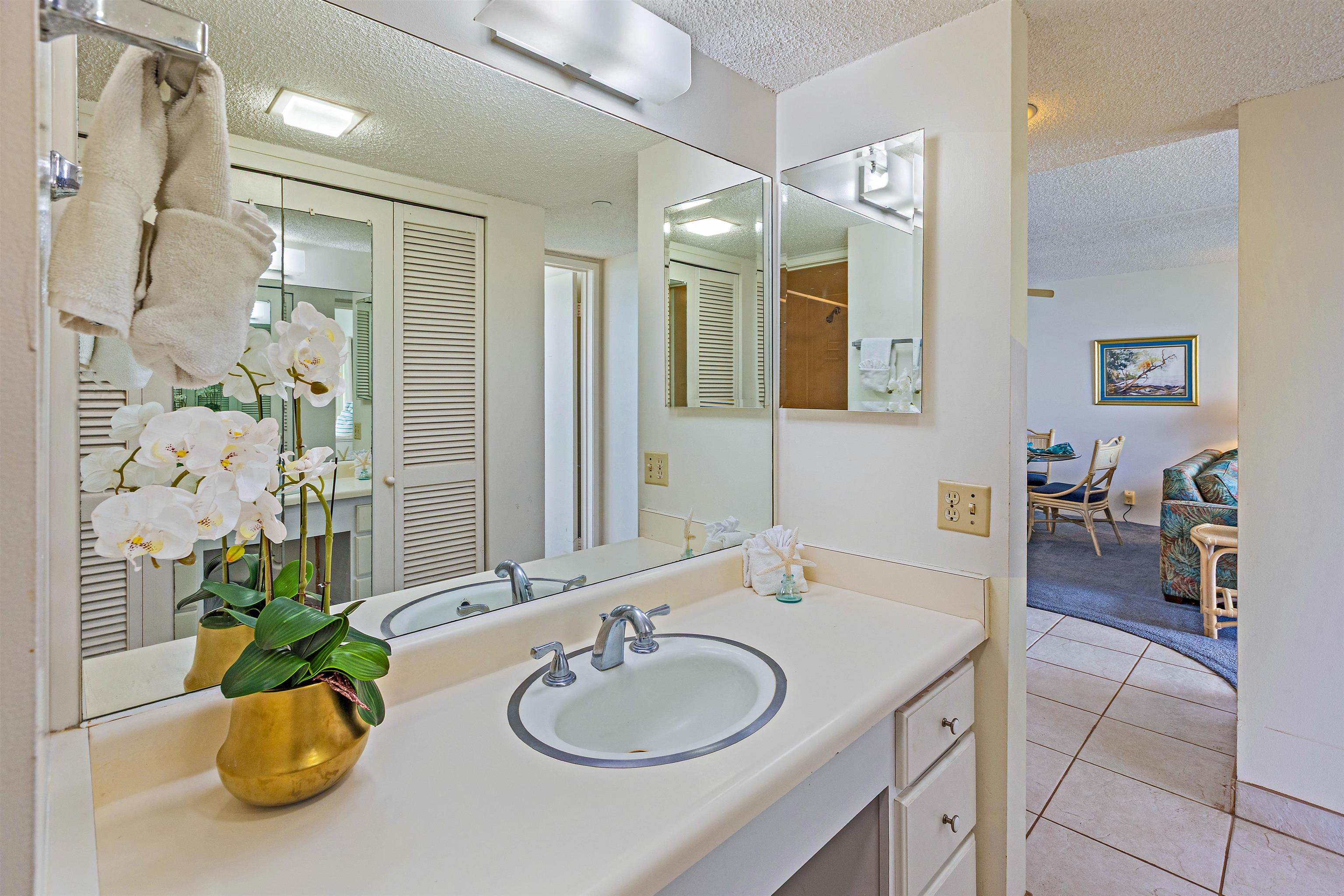 4327 Lower Honoapiilani Road, Unit 808 Lahaina, HI 96761 - Photo 19 of 35 a bathroom with a granite countertop sink and a mirror