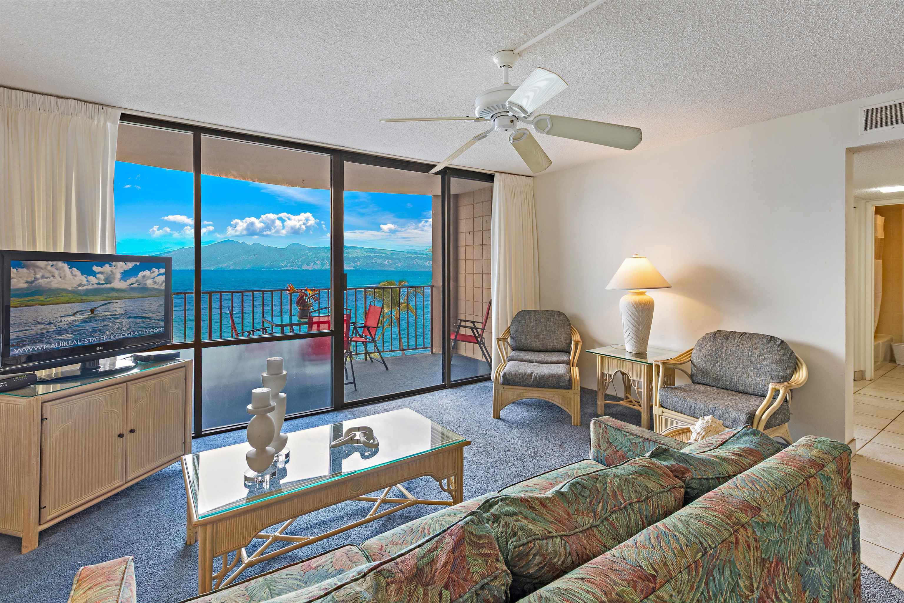 4327 Lower Honoapiilani Road, Unit 808 Lahaina, HI 96761 - Photo 3 of 35 a living room with furniture and a flat screen tv