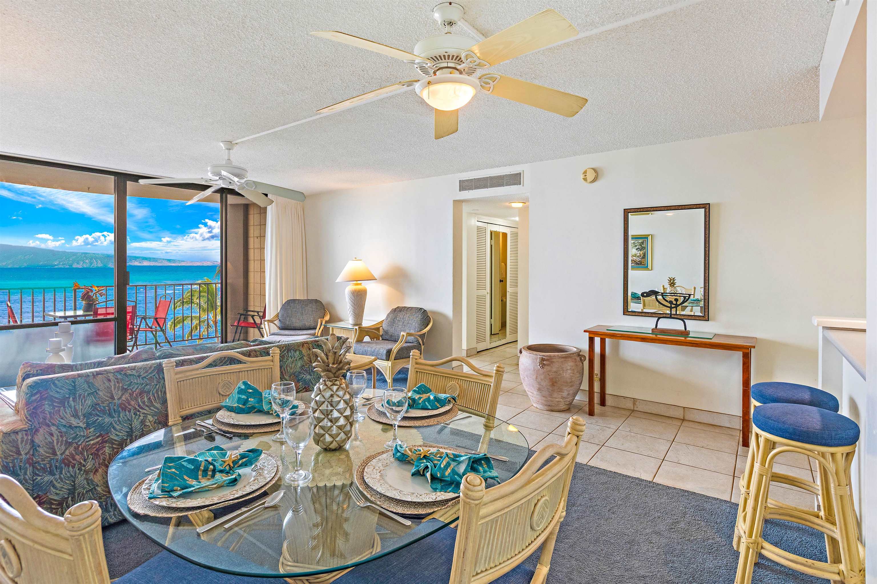 4327 Lower Honoapiilani Road, Unit 808 Lahaina, HI 96761 - Photo 5 of 35 a dining room with furniture a rug and a chandelier