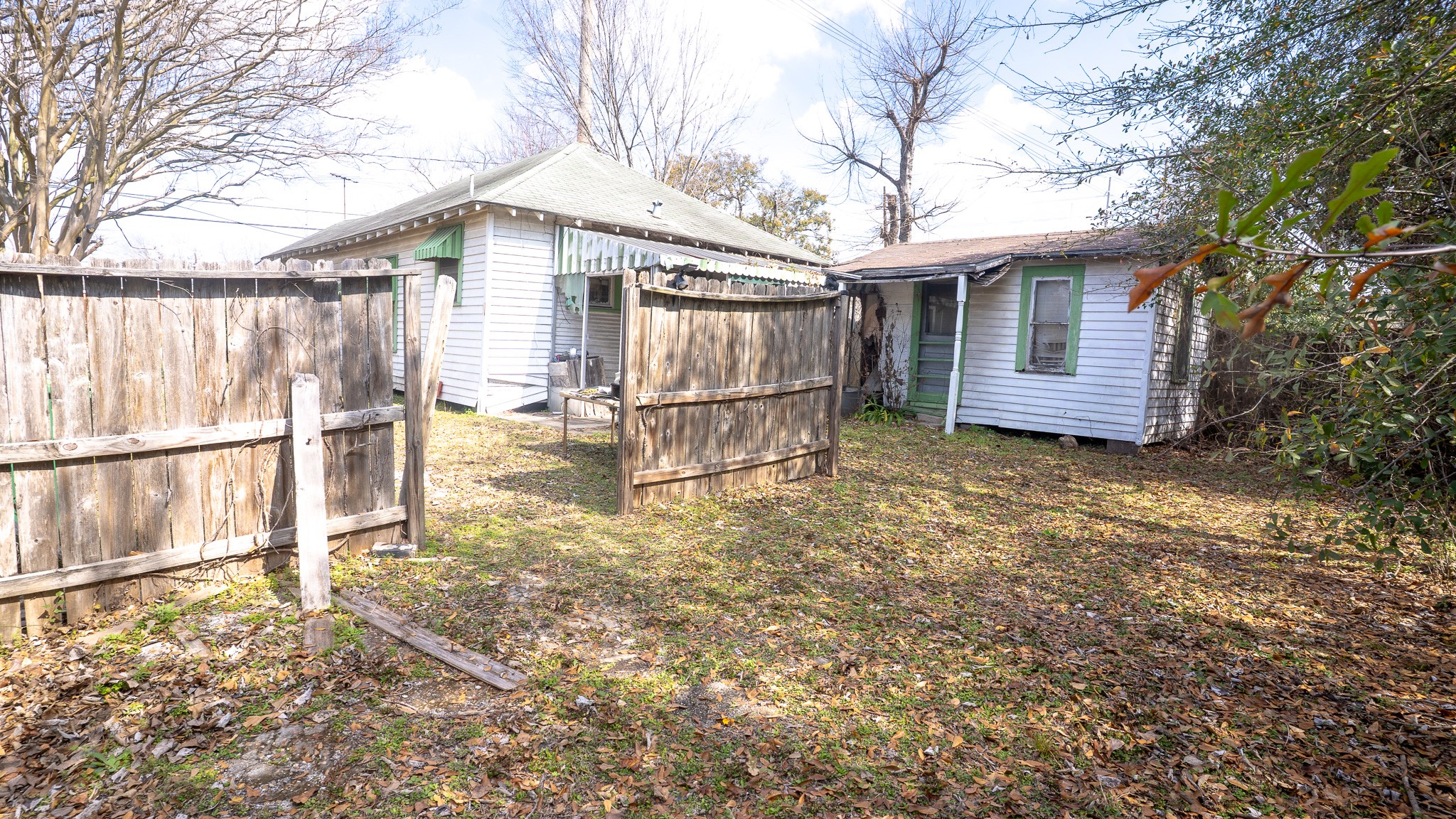8808 Leander Street Houston, TX 77012 - Photo 8 of 12 a view of a house with a large tree and a yard