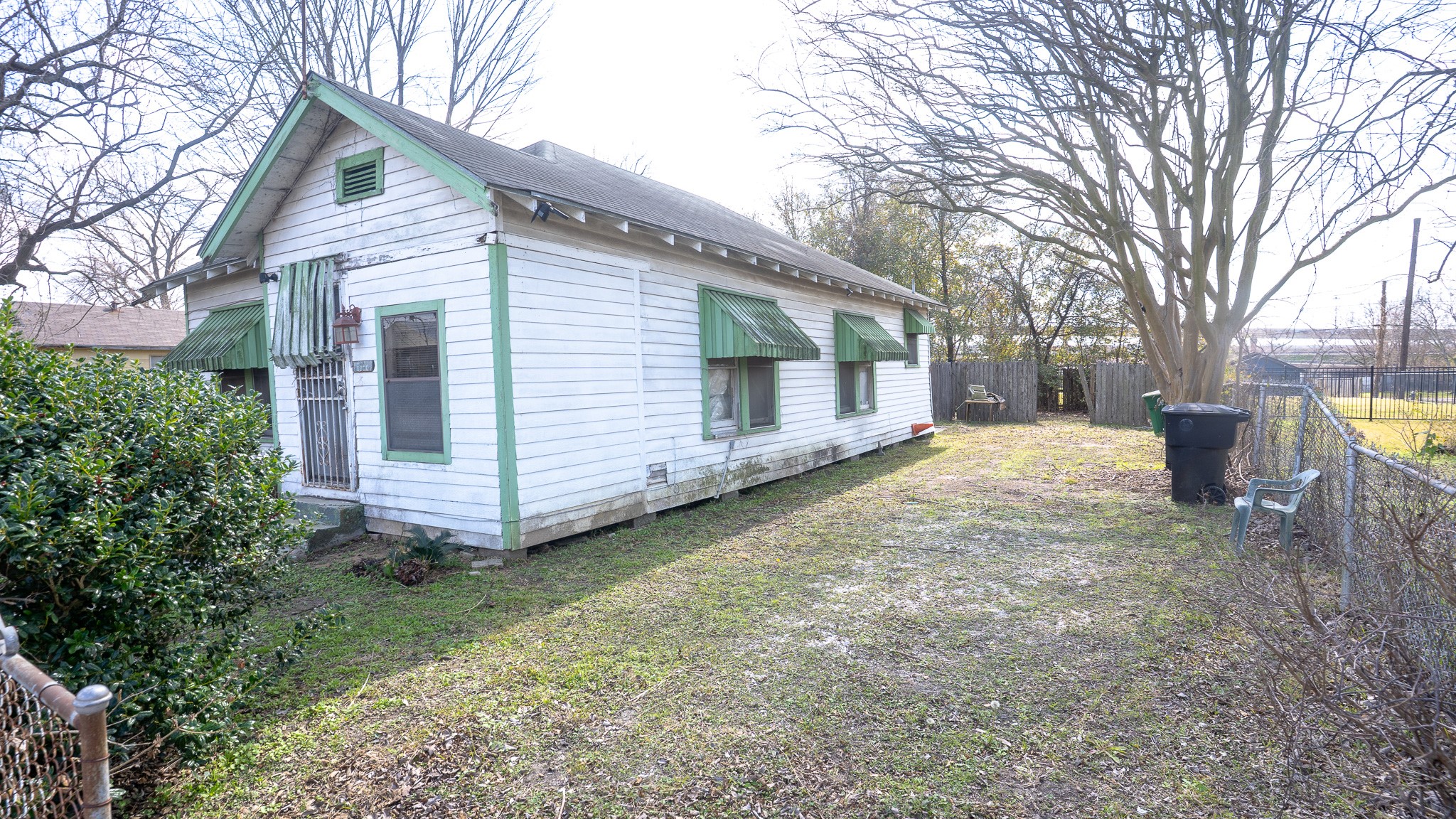 8808 Leander Street Houston, TX 77012 - Photo 10 of 12 a backyard of a house with large trees and barbeque oven