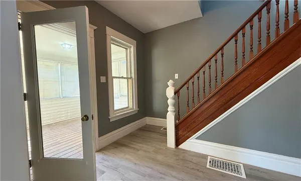 a view of an entryway with wooden floor