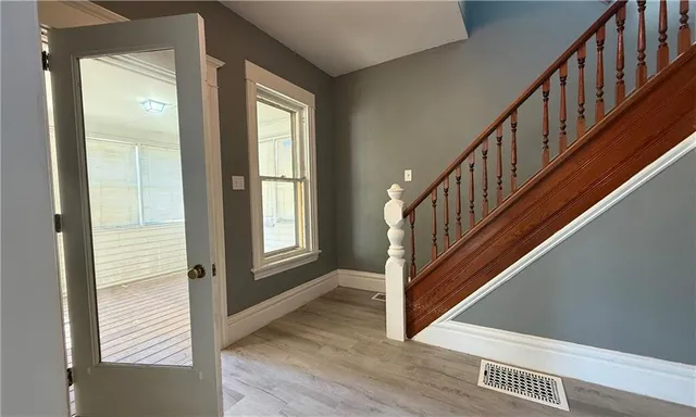 a view of an entryway with wooden floor