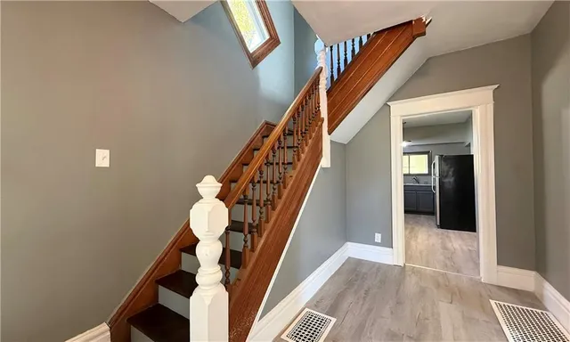 a view of entryway and hall with wooden floor