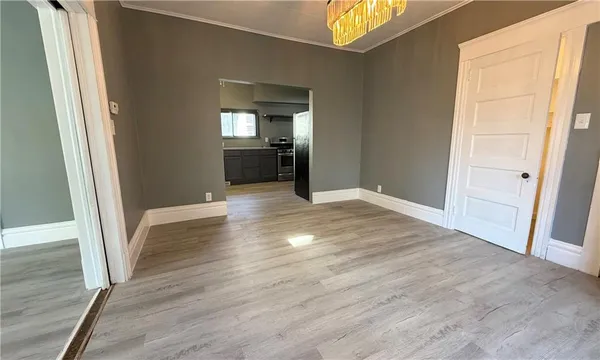 a view of a room with wooden floor and staircase