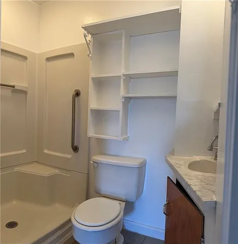 a bathroom with a granite countertop toilet a sink and a bathtub