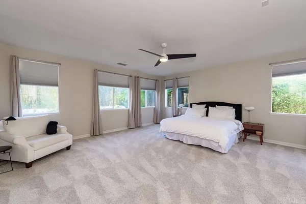 a spacious bathroom with a sink double vanity granite tub shower and a mirror