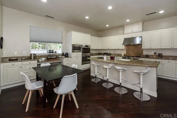 a spacious bedroom with a bed and a large window