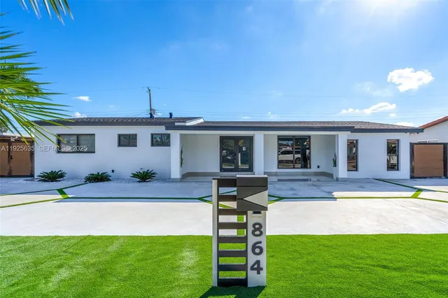 a front view of house with yard and outdoor seating