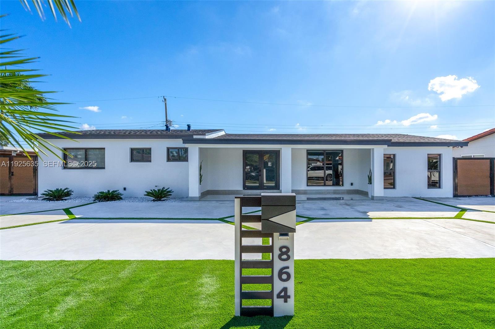 864 West 69th Place Hialeah, FL 33014 - Photo 1 of 45 a front view of house with yard and outdoor seating