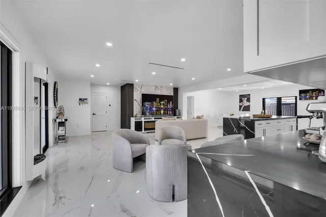 a living room with furniture and kitchen view