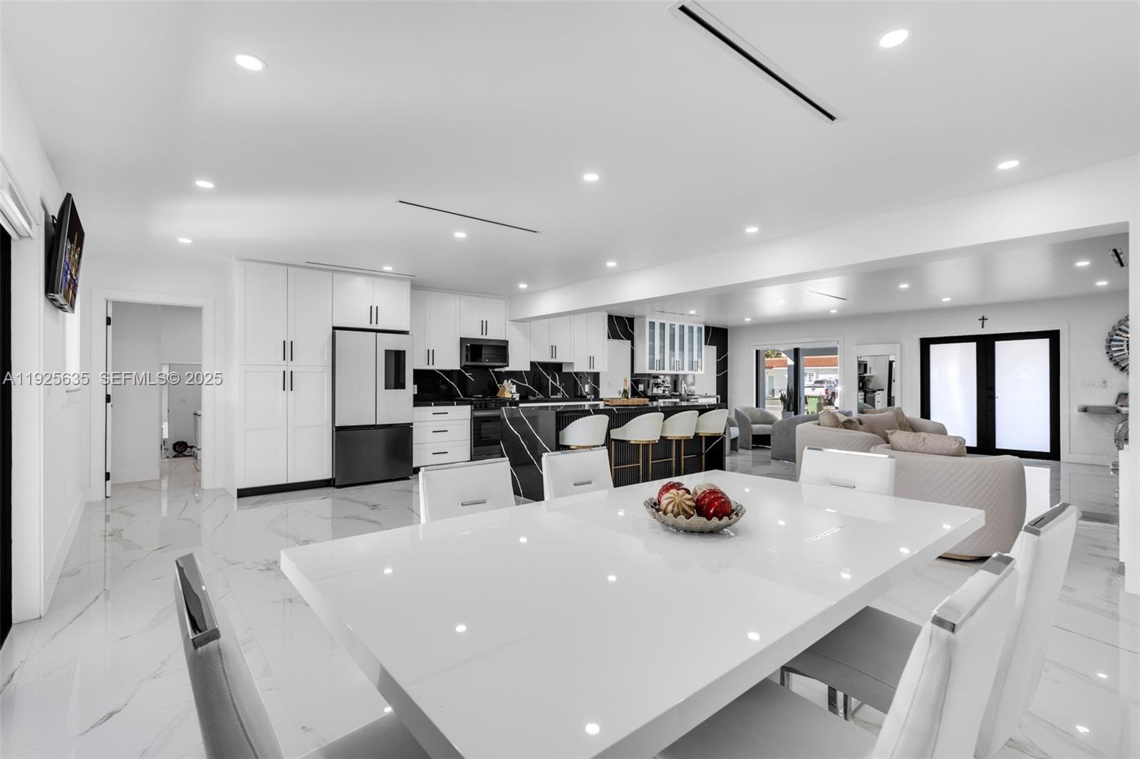 864 West 69th Place Hialeah, FL 33014 - Photo 14 of 45 a kitchen with a sink a refrigerator and chairs