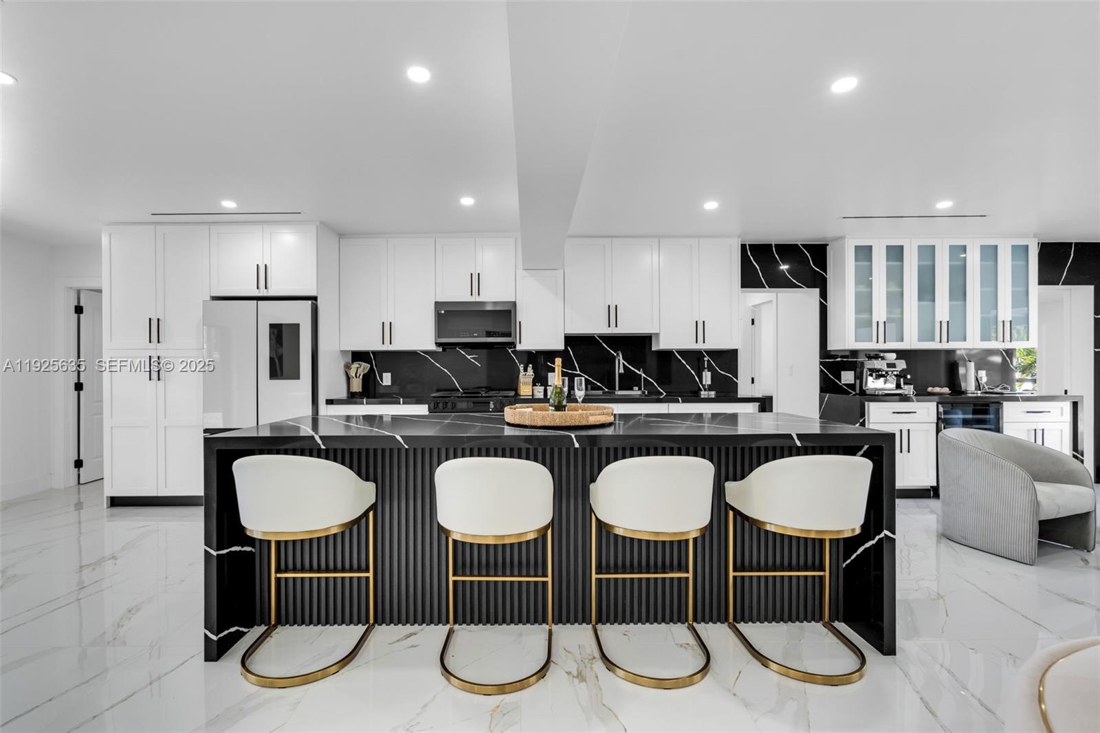 864 West 69th Place Hialeah, FL 33014 - Photo 15 of 45 a kitchen with stainless steel appliances granite countertop a dining table chairs stove refrigerator and cabinets