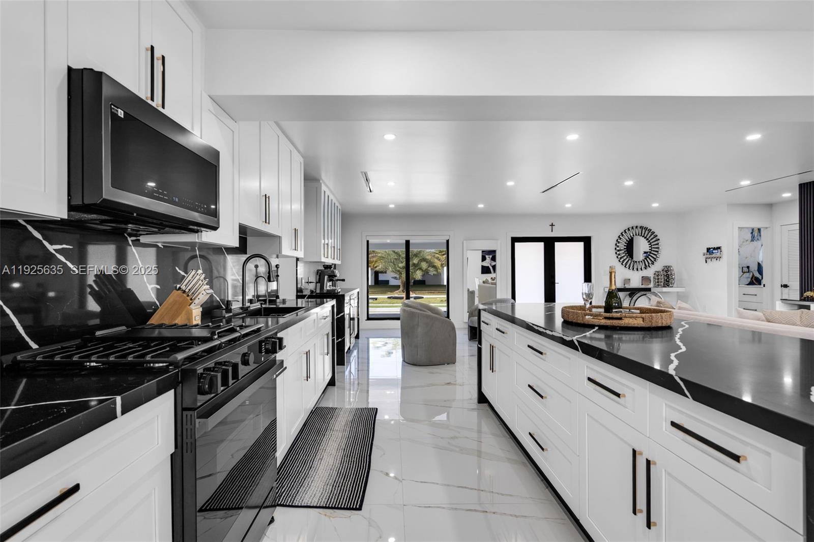 864 West 69th Place Hialeah, FL 33014 - Photo 16 of 45 a large kitchen with stainless steel appliances lots of counter space and a sink