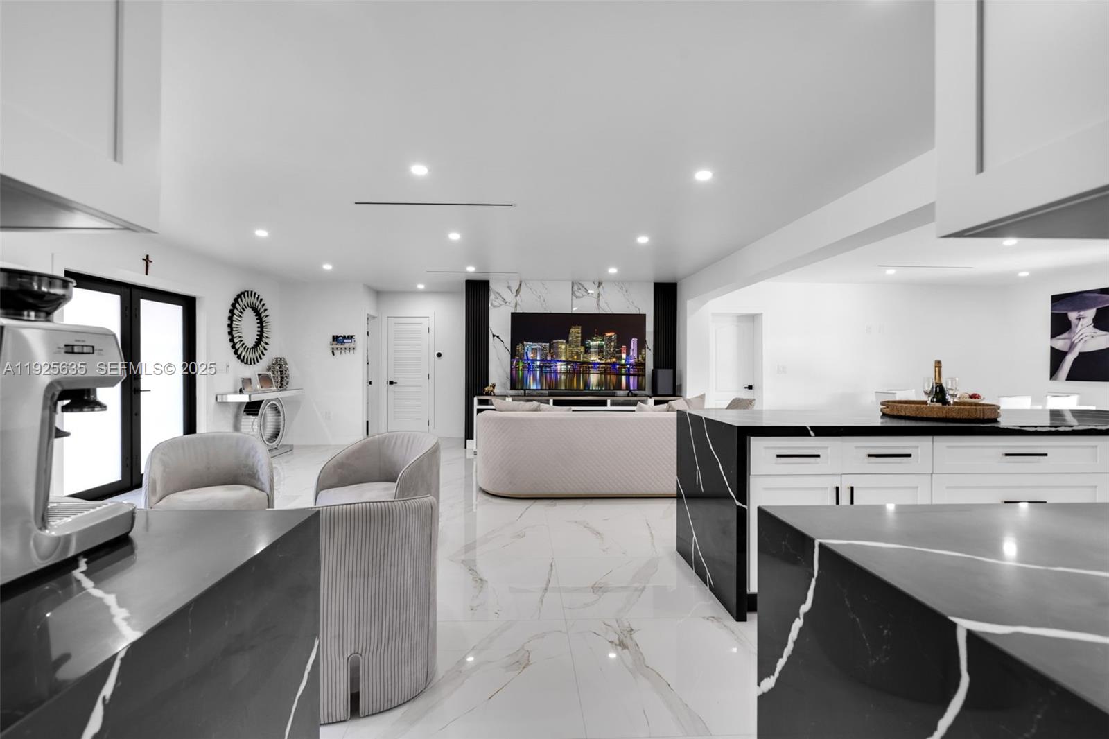 864 West 69th Place Hialeah, FL 33014 - Photo 18 of 45 a large kitchen with stainless steel appliances kitchen island granite countertop a table chairs sink and cabinets