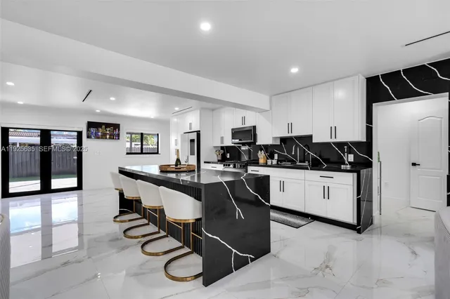 a kitchen with counter top space cabinets and stainless steel appliances