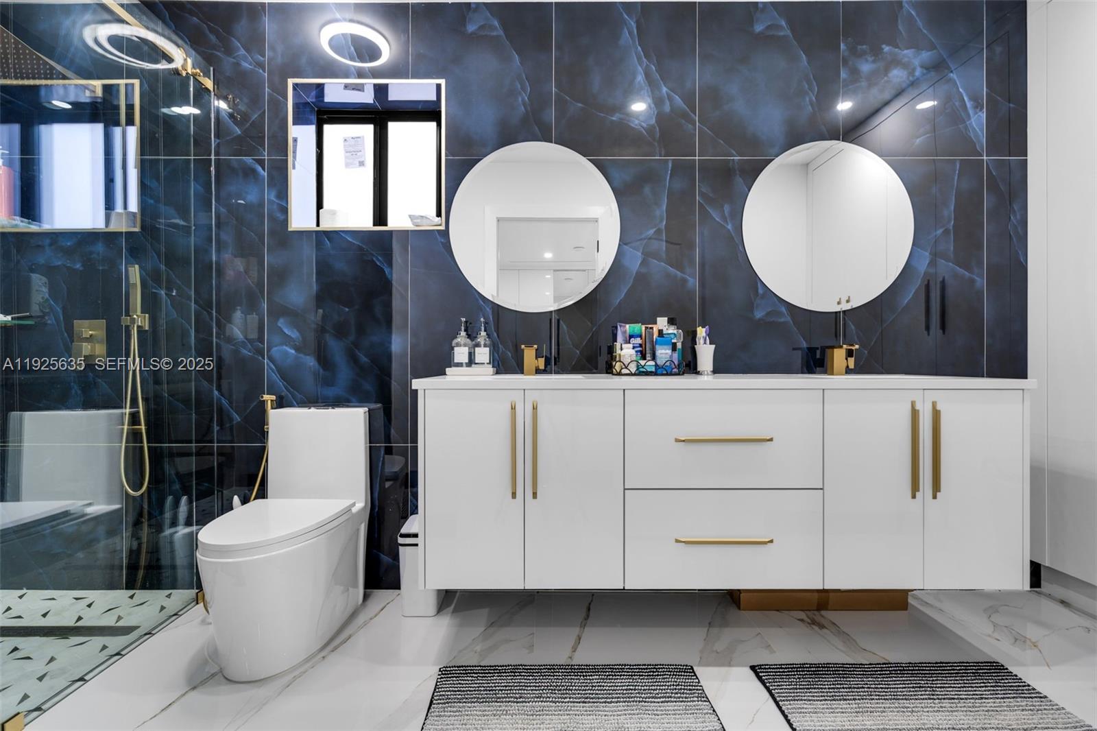 864 West 69th Place Hialeah, FL 33014 - Photo 24 of 45 a bathroom with a toilet a sink and mirror