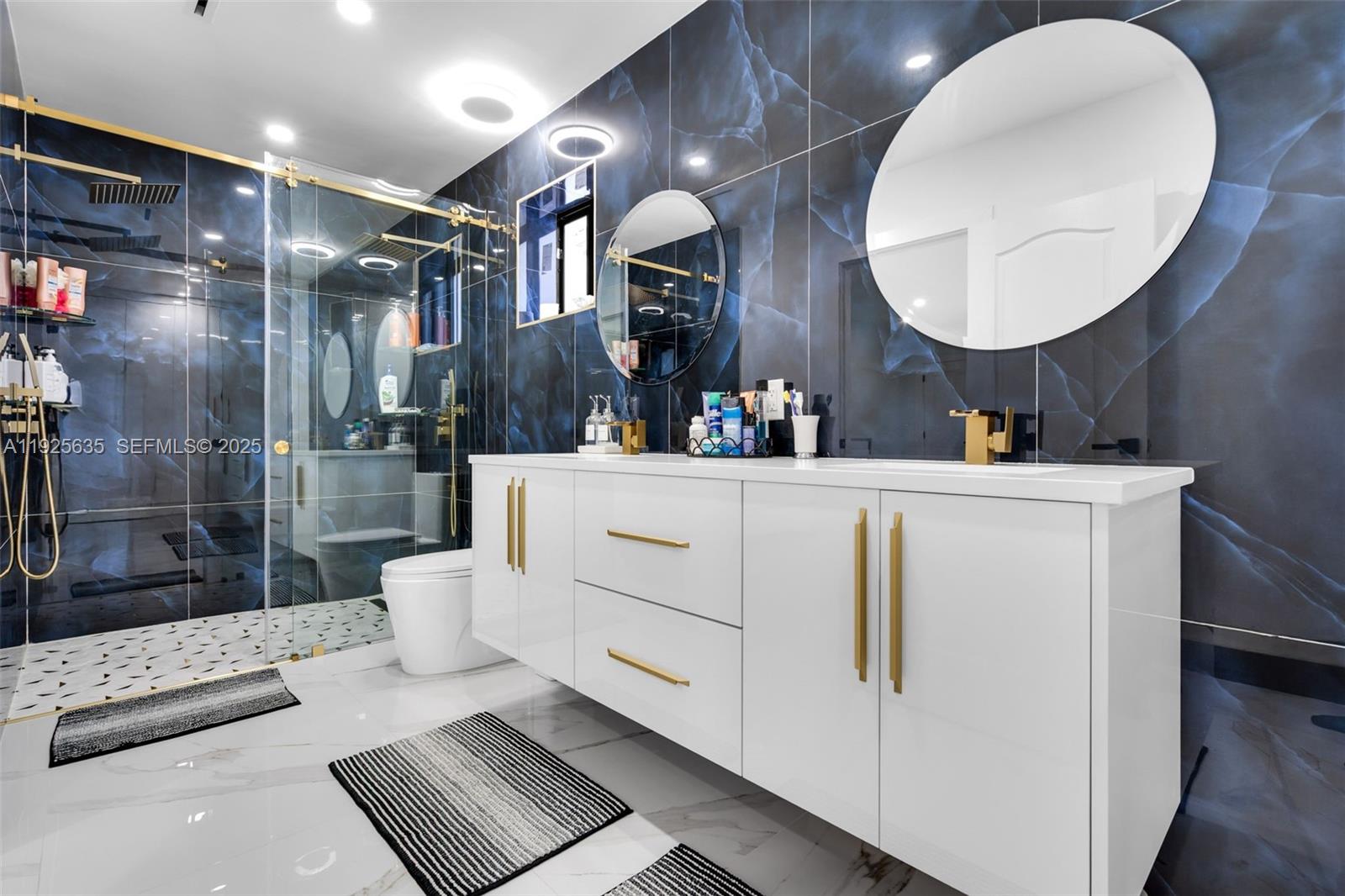 864 West 69th Place Hialeah, FL 33014 - Photo 25 of 45 a bathroom with a sink mirror and vanity