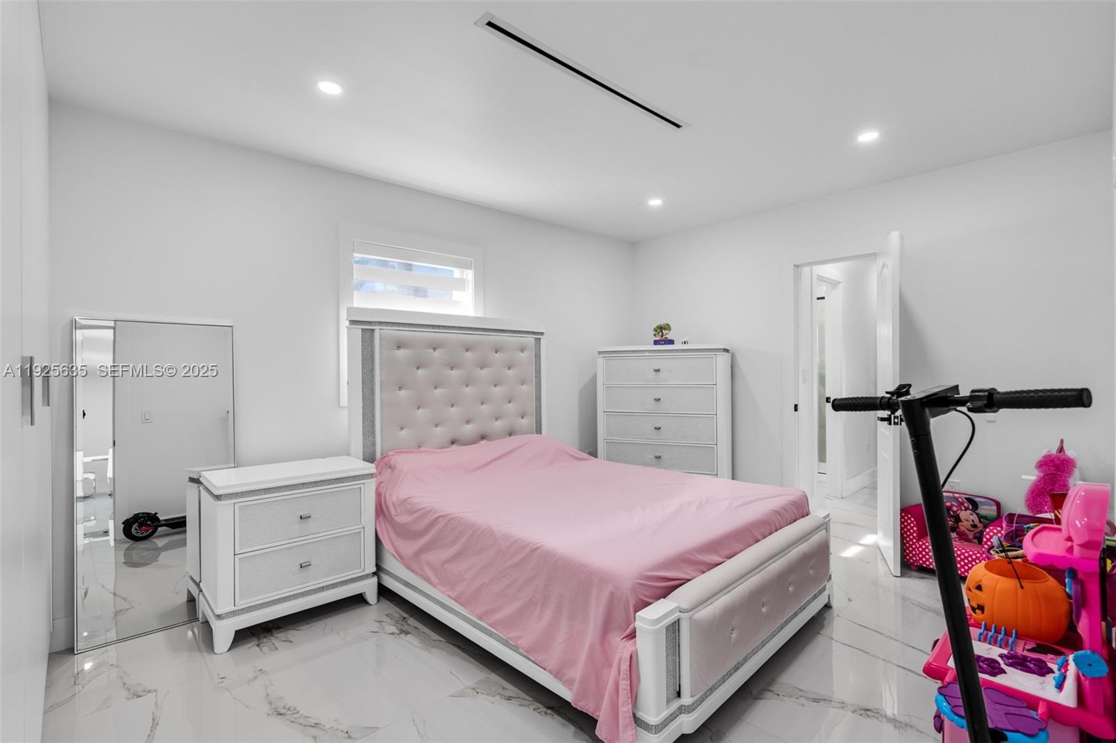 864 West 69th Place Hialeah, FL 33014 - Photo 27 of 45 a bedroom with a bed and a dresser