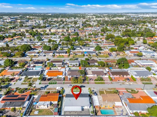 an aerial view of residential houses with outdoor space