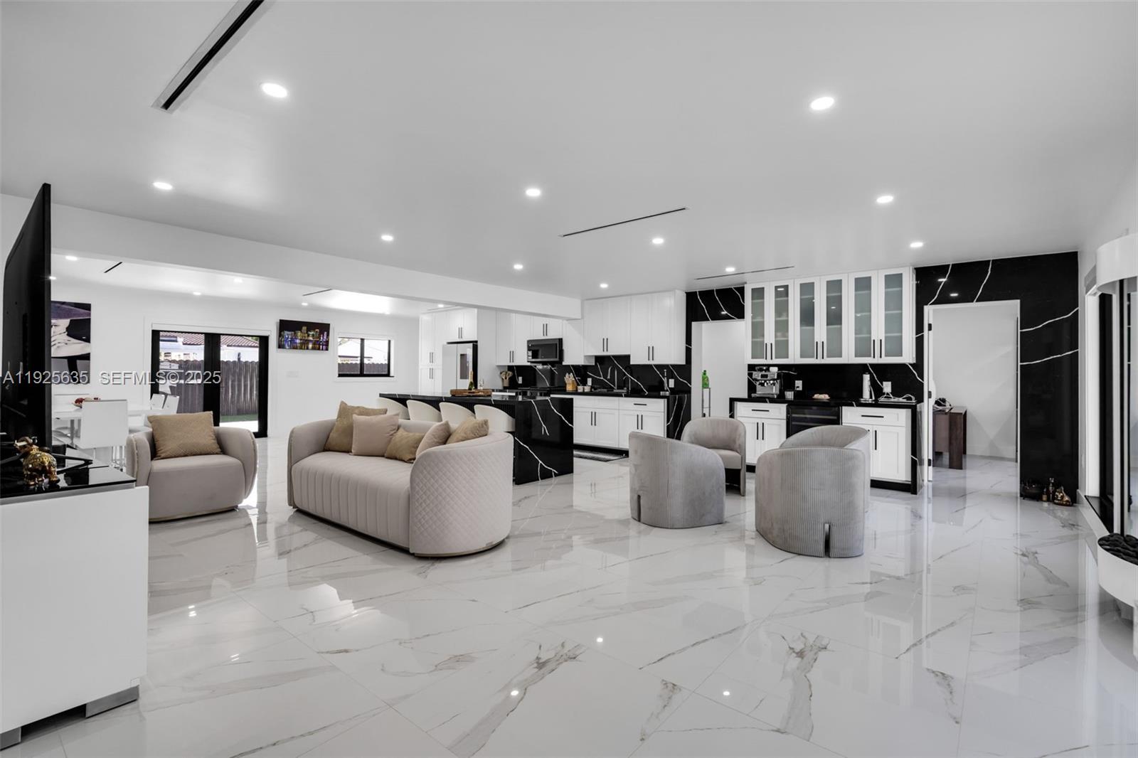 864 West 69th Place Hialeah, FL 33014 - Photo 10 of 45 a living room with lots of furniture and kitchen view