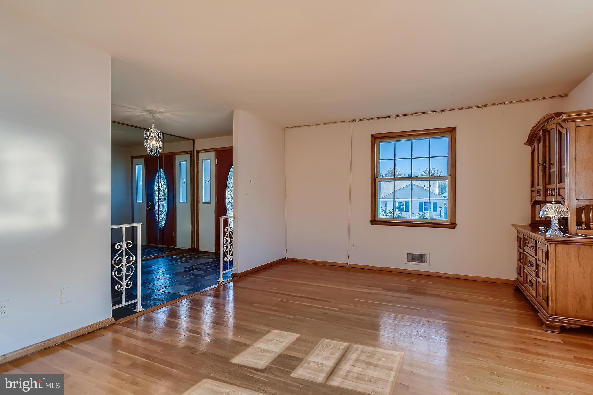 8918 Parlo Road Baltimore, MD 21236 - Photo 4 of 28 wooden floor in an empty room with a window